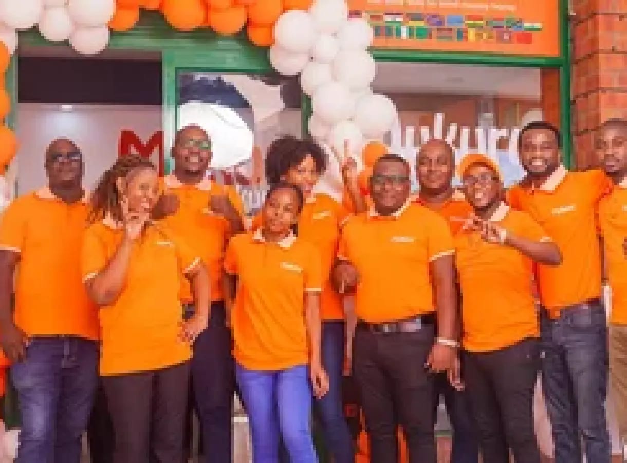 Mukuru branch consultants serving customers at a walk-in money transfer branch — the 540+ staff this story is about