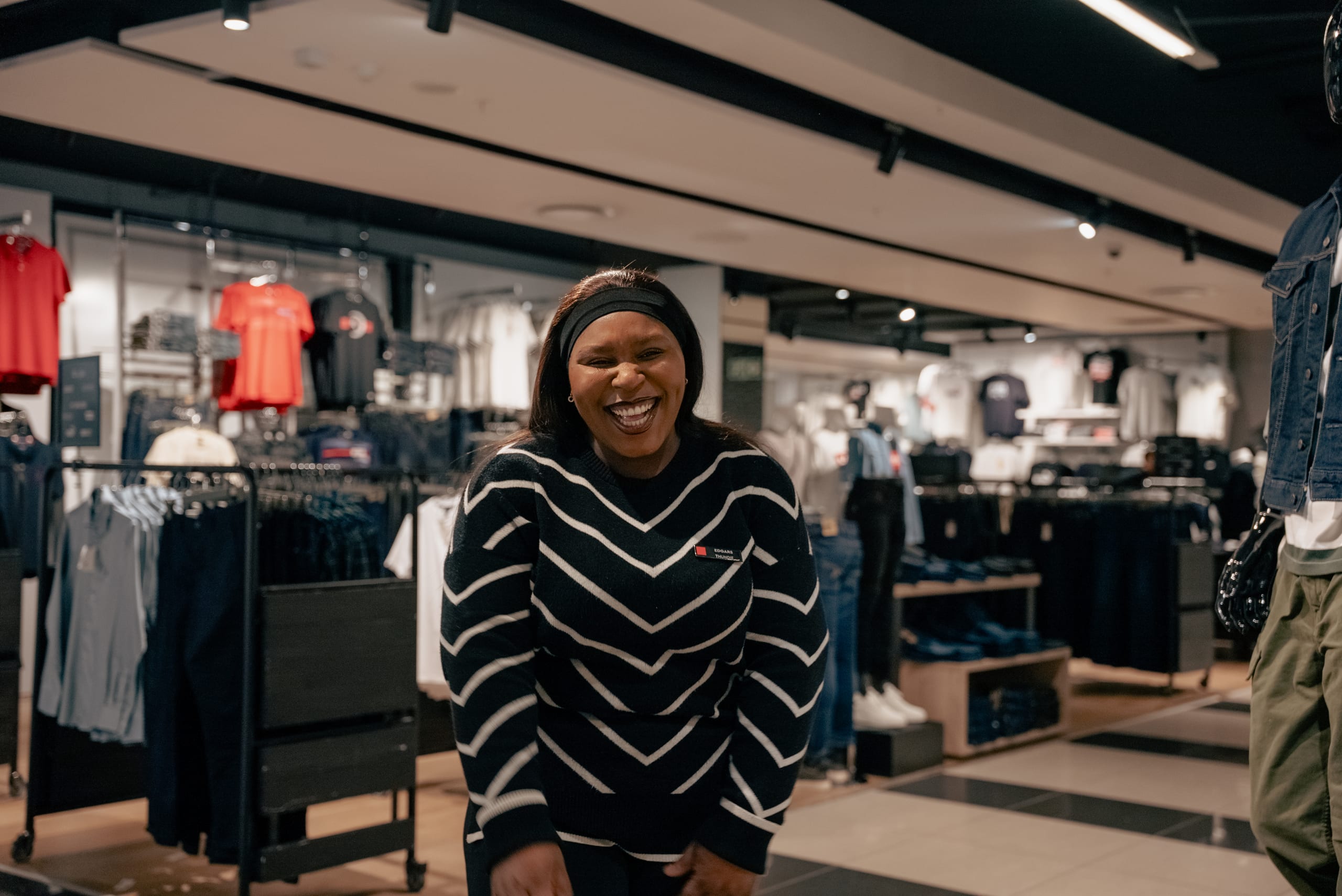 Retailability shop-floor staff in an Edgars or Legit store, on the floor among stock or at a till — the 7,500 people across roughly 450 stores this story is about